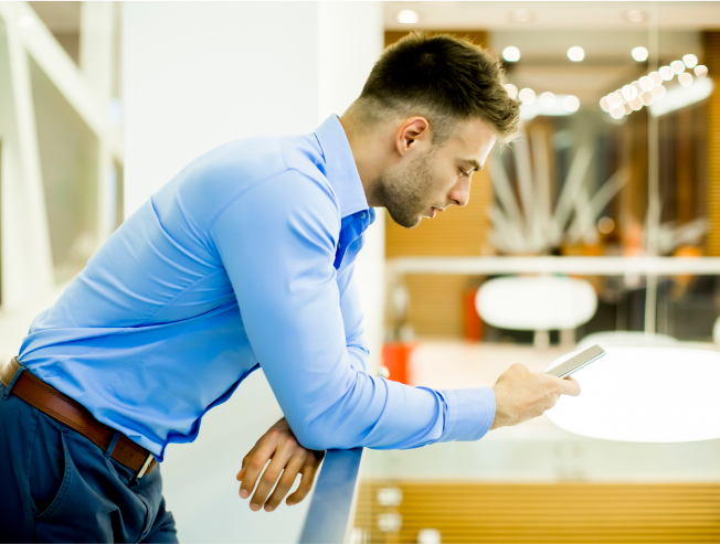 Young man with mobile phone in the office
