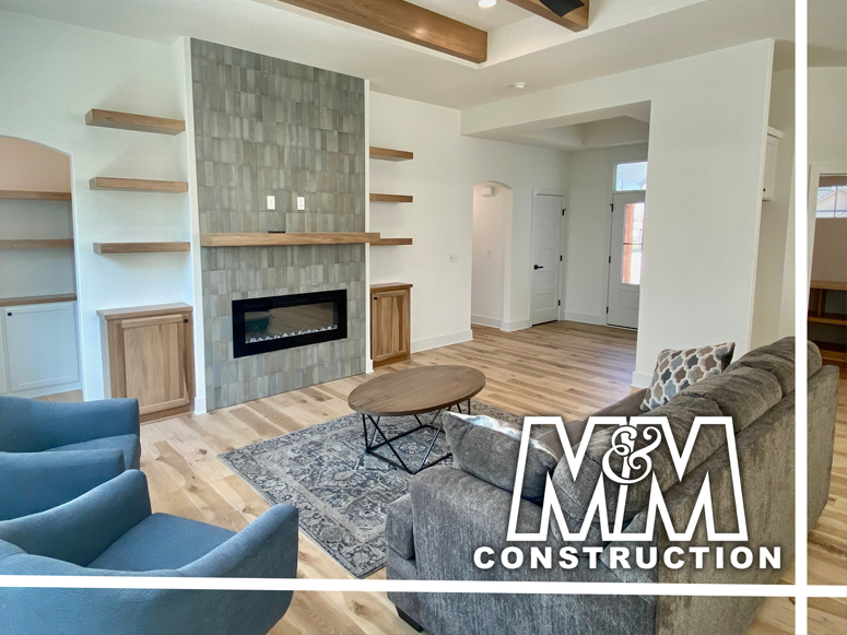 Interior design of living space with M&M Construction logo.