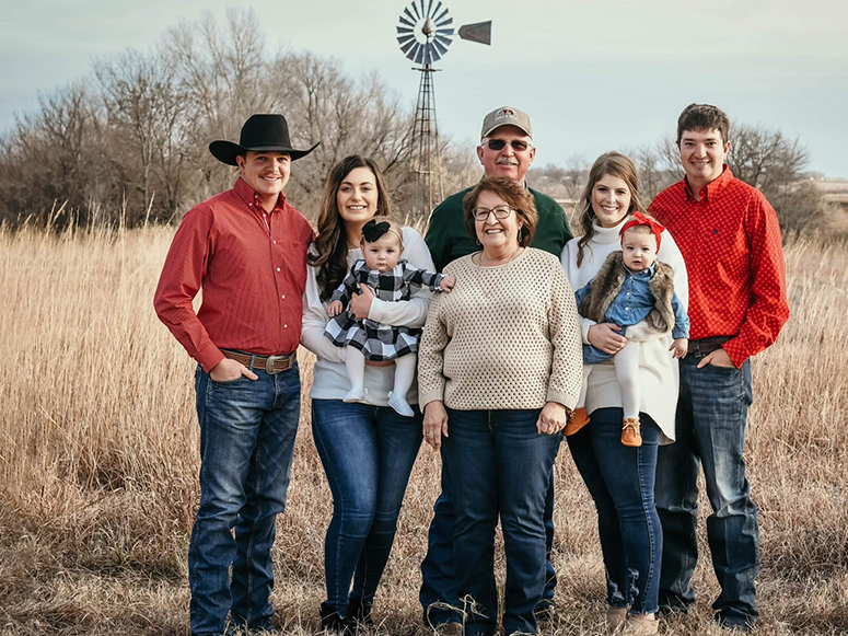 Strohl family photo in front of farm